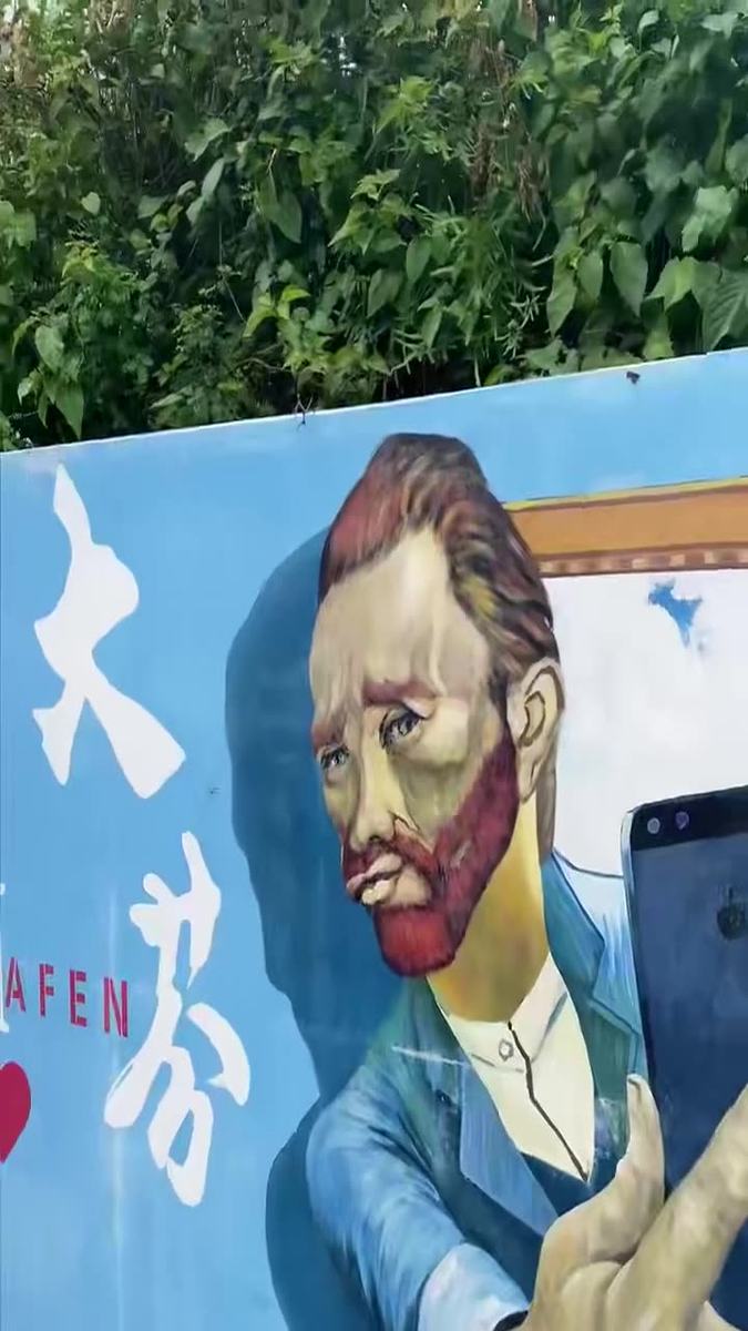 Dafen Oil Painting Village daily street life — gallery lanes and painter studios